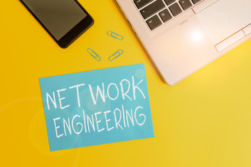 Text sign showing Network Engineering. Business photo showcasing field concerned with internetworking service requirement Trendy open laptop smartphone small paper sheet clips colored background