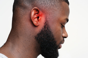 Black guy with inflamed ear, side view