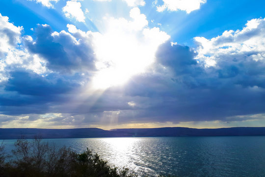 Landscape of the Sea of Galilee - Sea of Galilee. Clouds above the lake. The sun's rays break through the clouds.
