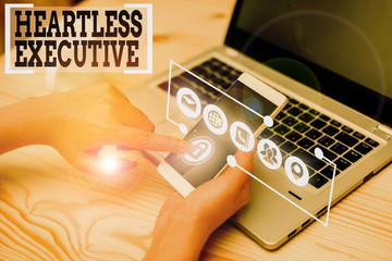 Conceptual hand writing showing Heartless Executive. Concept meaning workmate showing a lack of...