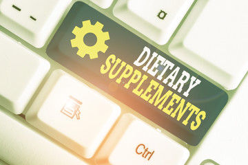 Writing note showing Dietary Supplements. Business concept for Product taken orally intended to...