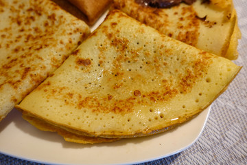 Traditional Russian pancakes on a plate. Handmade. Wedge syrup