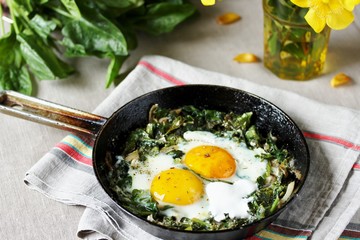 shakshuka with spinach or fried eggs. Green Shakshuka. Cook in Israel. Paleo. Keto diet dish. 