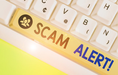 Writing note showing Scam Alert. Business concept for fraudulently obtain money from victim by...