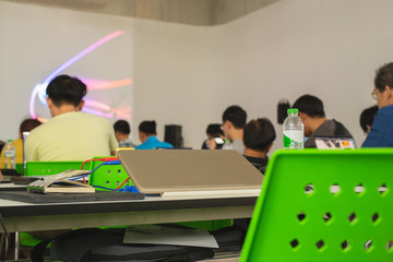 Selected focus on laptop with student study in classroom.