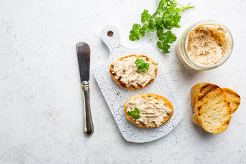 Sandwiches with salmon pate and baguette, fish bruschetta, top view. Rustic homemade Italian cuisine.