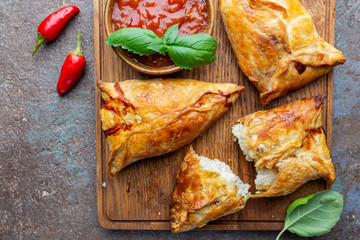 Asian food Samsa or samosas with chicken fillet on cutting board. Top view