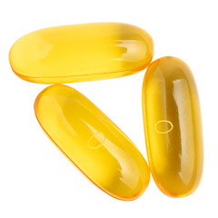 Omega 3 supplement, fish oil yellow capsules isolated on white background, macro image, top view