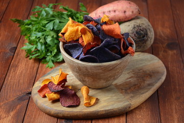 Baked vegetable chips- garnet sweet potato, purple sweet potato,carrot and beetroot. Gluten-free,...