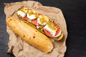 Goat cheese and honey sub sandwich on dark background