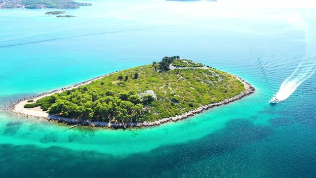 Beautiful blue seascape, small islands and boat on Adriatic sea in Croatia near Pakostane, drone circle aerial footage
