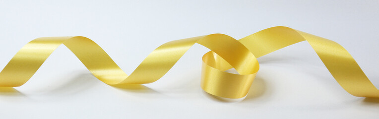 Gold ribbon isolated on white background. Stock photo.