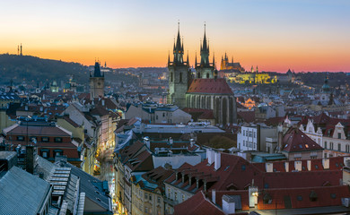 Prague - The City with the Church of Our Lady before Týn and Castle with the Cathedral in the background at dusk.