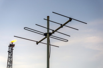Obraz premium Radio antenna on board a construction work barge at oil field