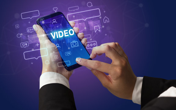Female hand typing on smartphone with VIDEO inscription, social media concept