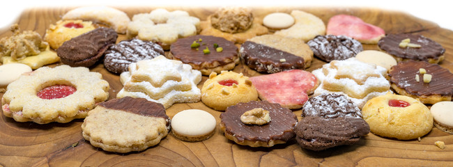 colorful mix of homemade christmas cookies on a wooden board