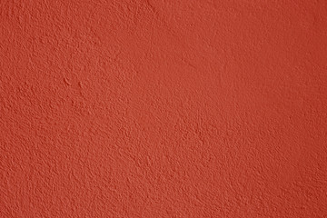 Old peeling paint on the wall. Red abstract background. Beautiful red textured stucco on the wall....