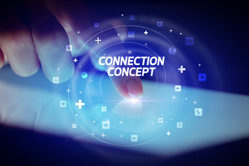 Finger touching tablet with social media icons and CONNECTI N CONCEPT