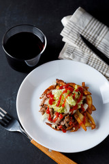 Traditional cuban potatoes with minced meat, lettuce and onion