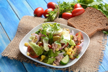 Tuna salad with lettuce, eggs and tomatoes, cucumber, corn and red onion. Healthy Mediterranean food concept