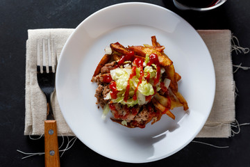Traditional cuban potatoes with minced meat, lettuce and onion