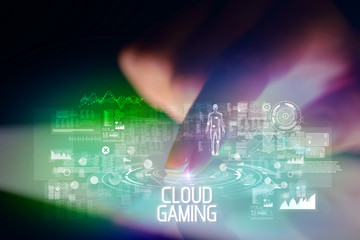 Finger touching tablet with web technology icons and CLOUD GAMING inscription