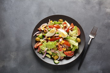Tuna salad with lettuce, eggs and tomatoes, cucumber, corn and red onion. Healthy Mediterranean food concept