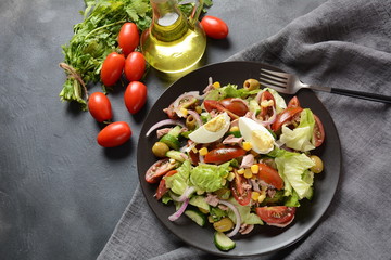 Tuna salad with lettuce, eggs and tomatoes, cucumber, corn and red onion. Healthy Mediterranean food concept