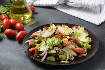 Tuna salad with lettuce, eggs and tomatoes, cucumber, corn and red onion. Healthy Mediterranean food concept