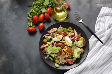 Tuna salad with lettuce, eggs and tomatoes, cucumber, corn and red onion. Healthy Mediterranean food concept