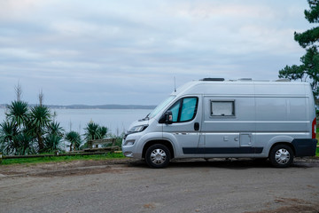 campervan rv parked on seaside in winter sunrise vanlife day in french coast in cap ferret village france
