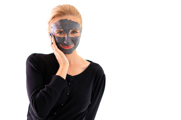 Smiling woman on casual dress with purifying black mask on her face isolated on white background.