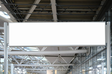 Blank white mockup of bus stop vertical billboard in front of empty street background.