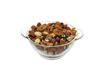 Assorted different nuts in a transparent plate on a white background