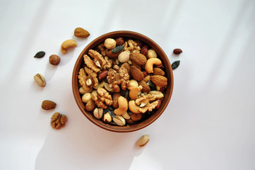 clay plate with nuts on a white background