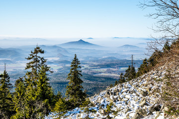 Ralsko Mountain rising from the mist. Weather temperature inversion in Central Bohemian Uplands,...