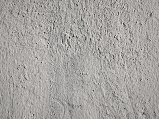 Old peeling paint on the wall.  Gray abstract background. Beautiful gray textured stucco on the wall. Background from gray stucco.