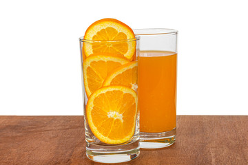 glass of juice with slice of orange on a background