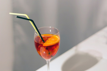 Aperol spritz cocktail in glass with straws. Party, bar, menu concept. Close-up, copy space
