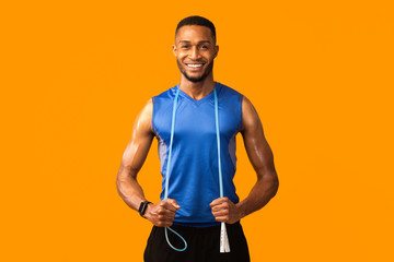 Afro sportsman with jumping rope at studio