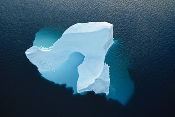 Aerial view of large glacier and iceberg - obrazy, fototapety, plakaty