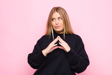 young blonde woman scheming and conspiring, thinking devious tricks and cheats, cunning and...