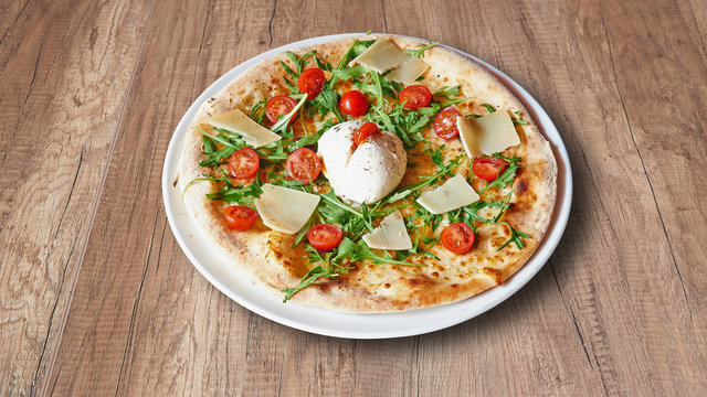 Plate of Delicious italian food on Textured wooden background