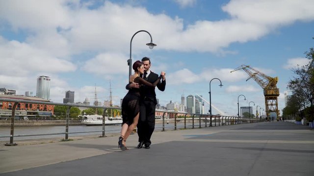 A couple of tango dancers performing on a windy day in Buenos Aires