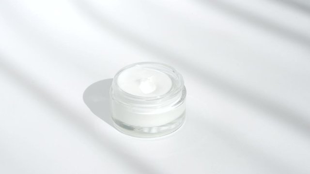 White facial cream jar. Cosmetic moisturizing product. Skin and body care, moisture lotion, wellness therapy mask in glass jar