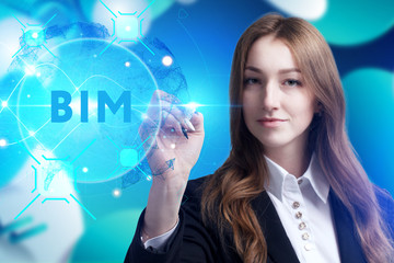 Business, Technology, Internet and network concept. Young businessman working on a virtual screen of the future and sees the inscription: BIM