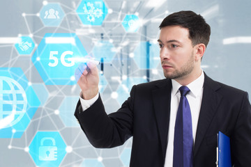 Obraz premium Business, Technology, Internet and network concept. Young businessman working on a virtual screen of the future and sees the inscription: 5G