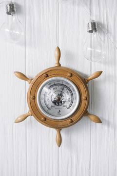 Sea barometer on a white wooden background