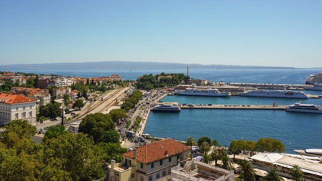View of the southern part of Split from the bell tower of the Split Palace. Port, moorings, promenade, ships, railway station, tram tracks, island of Brac