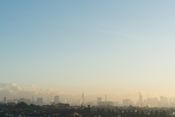 Far view of Kuala Lumpur city skyline in hazy and misty morning